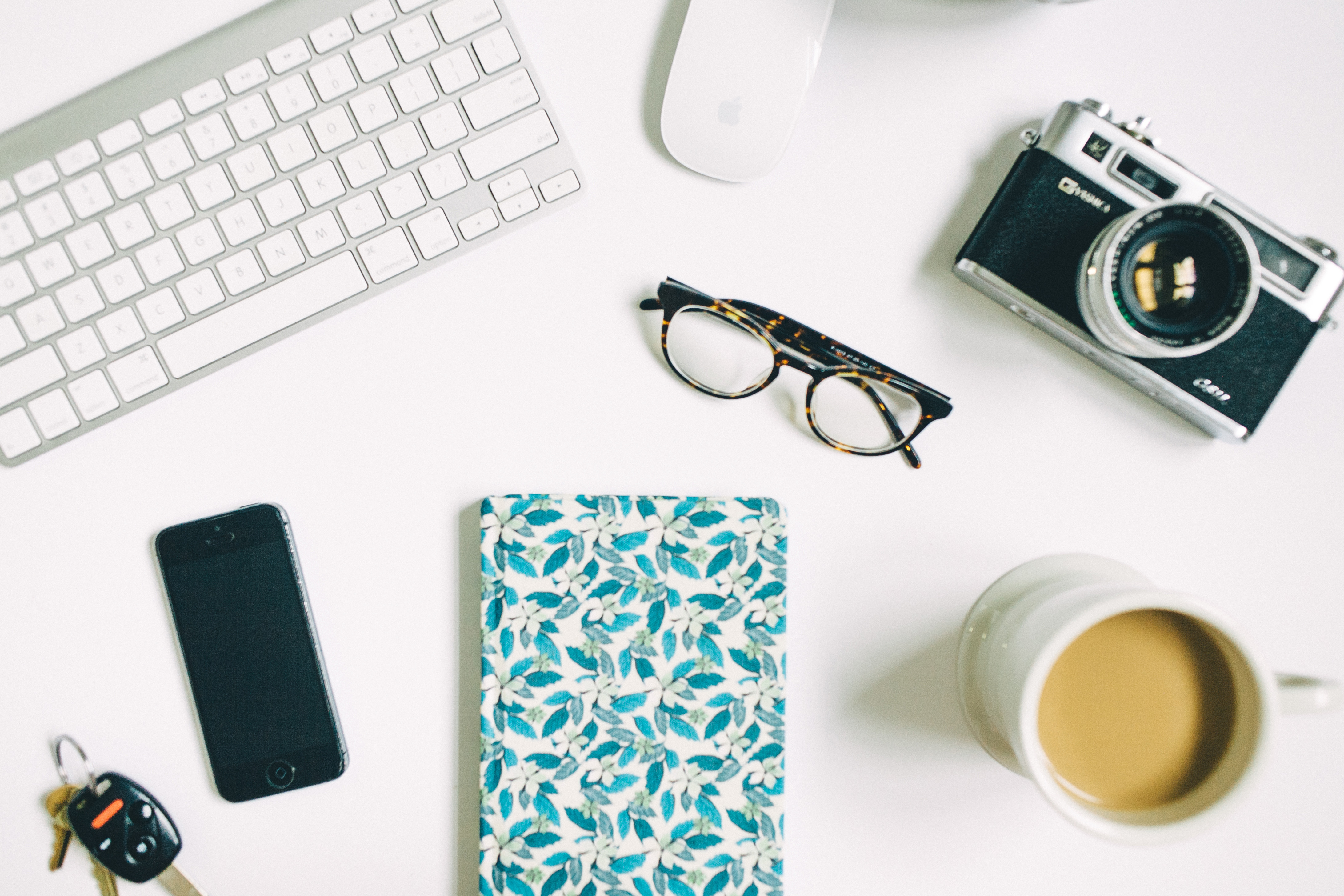 your first resume shows your skills as seen in camera, mac and notebook on top of a white table