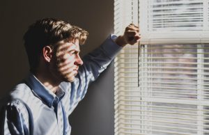 a man facing the window and considering to change career
