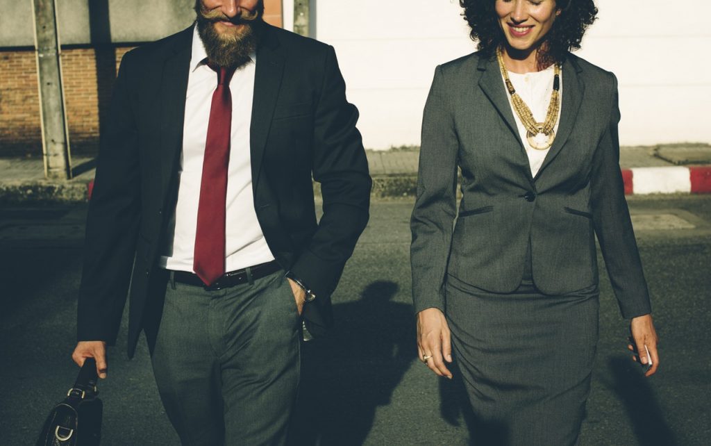 man and woman walking and talking - how to deal with your new boss