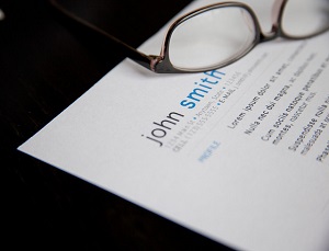 resume and eyeglass on a table