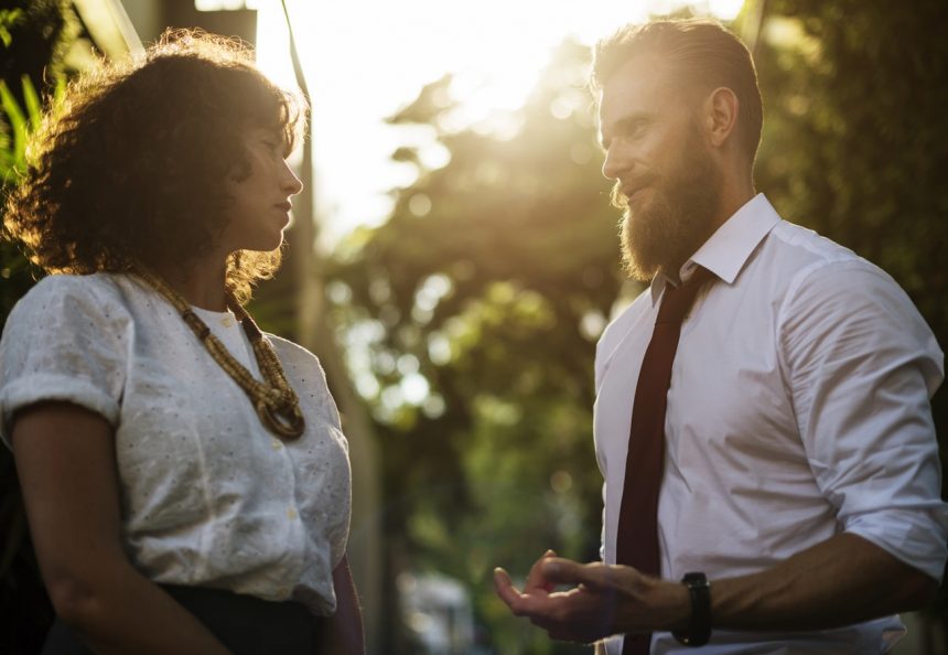 man giving tips to a female friend about hiring resume writer