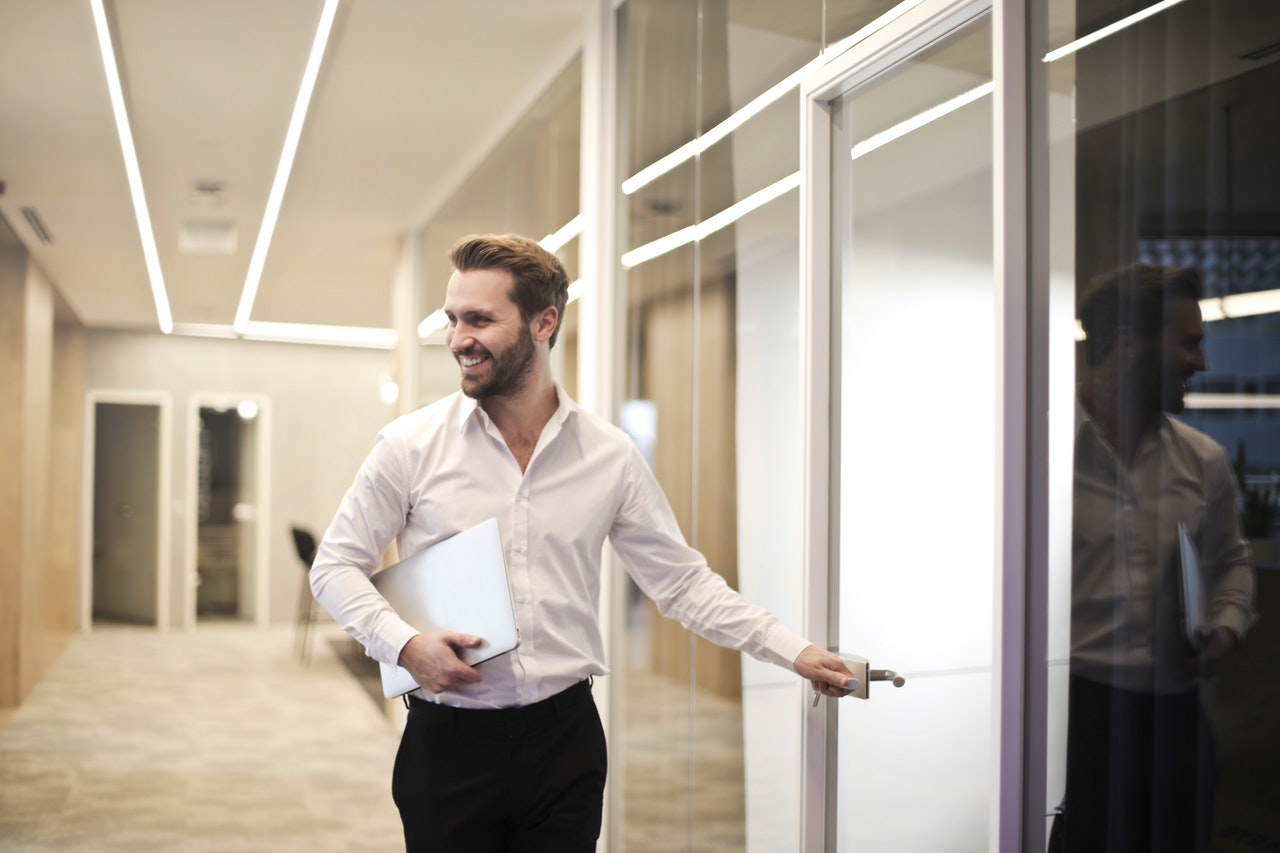 a happy applicant leaving the interview room because he knows that he got the job