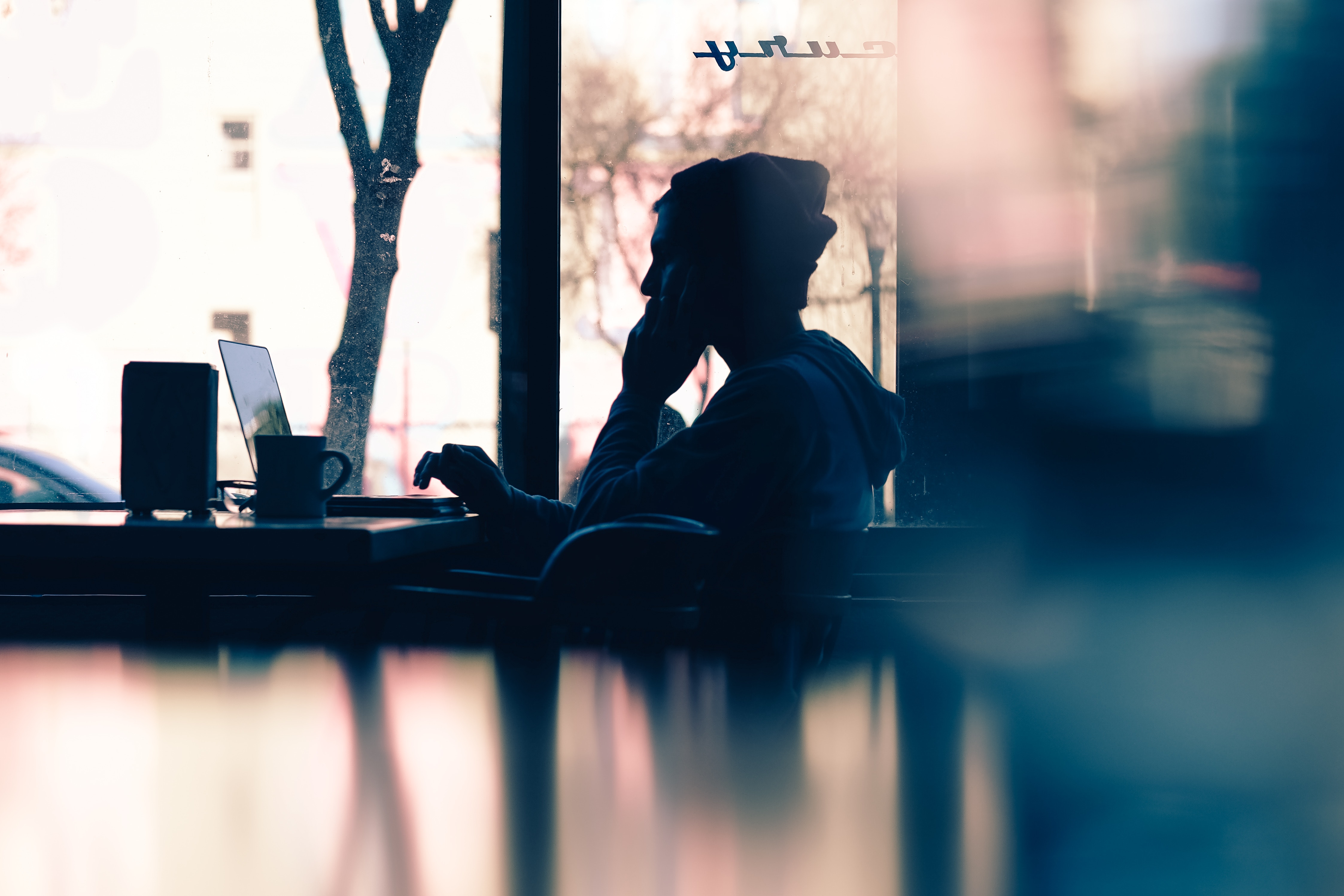 freelance jobs - man at a coffee shop with laptop