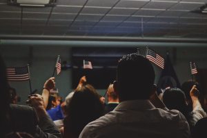 Trump Immigration Policy people holding little american flags