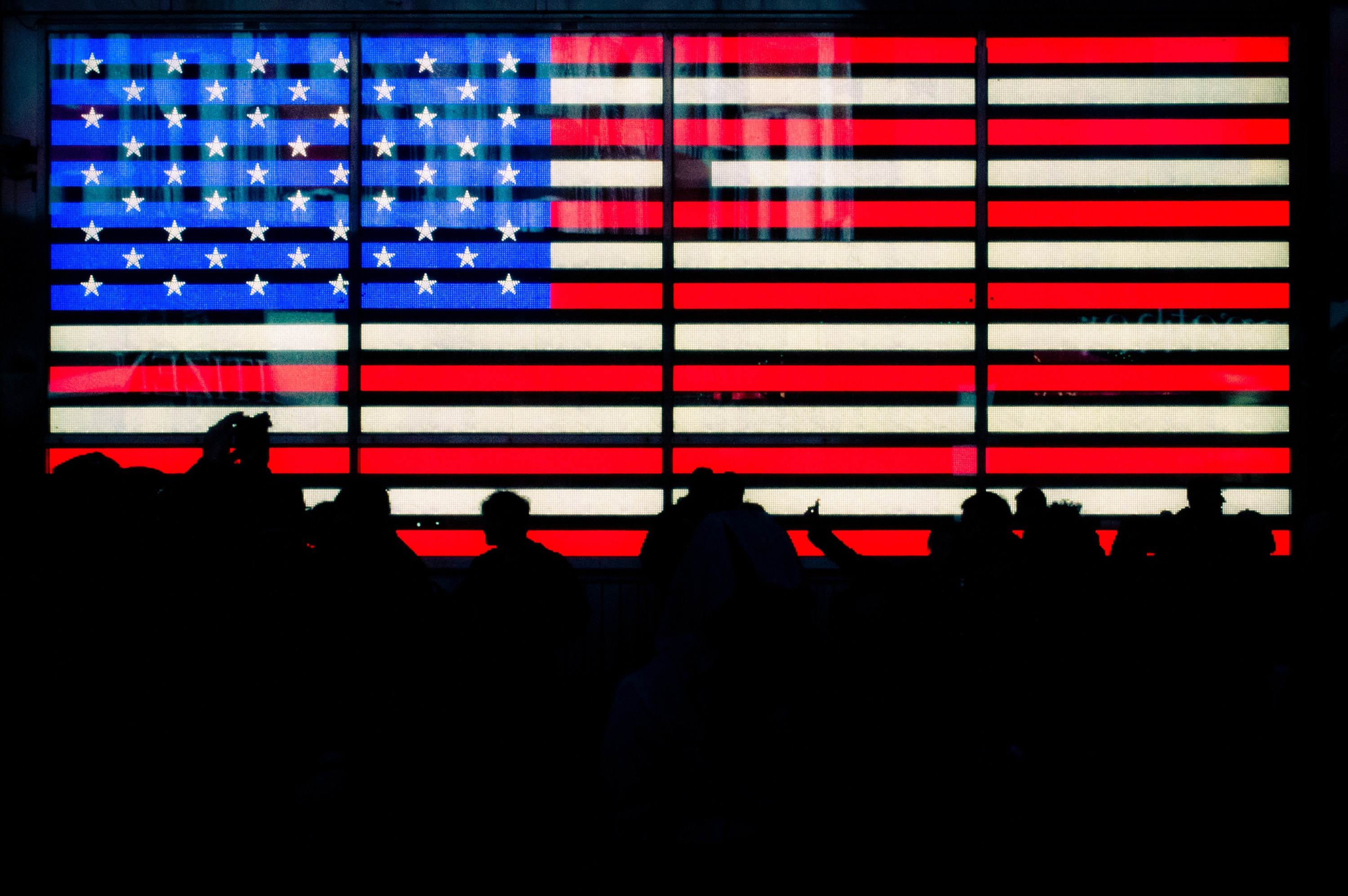 election jobs silhouette of people and the american flag on LCD screen