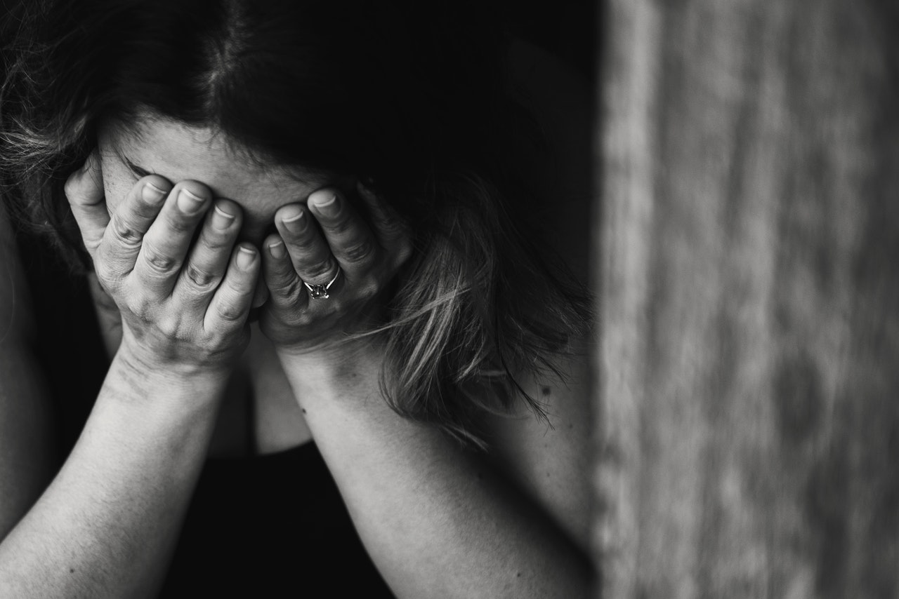 a black and white picture of a girl who suffers from mental health illness