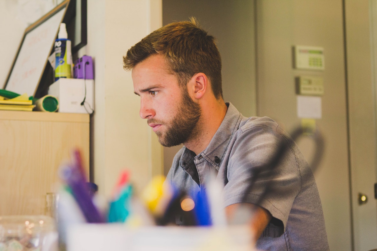 a man facing his computer searching about mental health