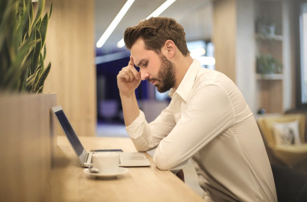 a man thinking about disclosing mental health illness to his boss