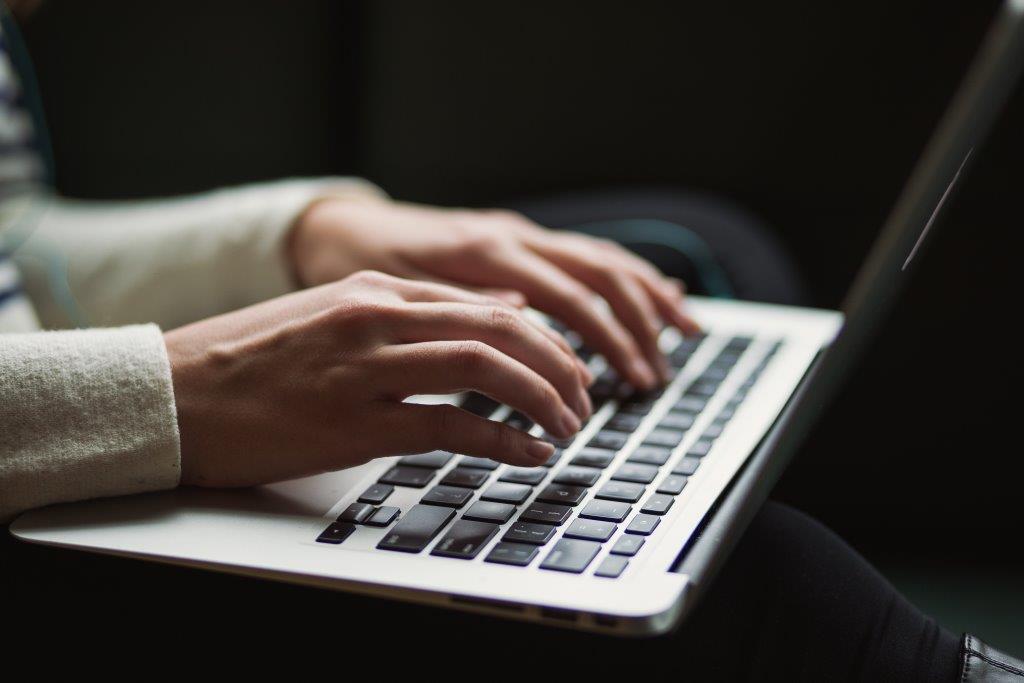 job seeker writing her self-employed resume