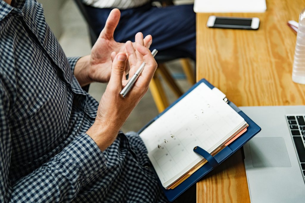 Man Holding a Pen: Operations Manager Job Description for Aspiring Job Applicants