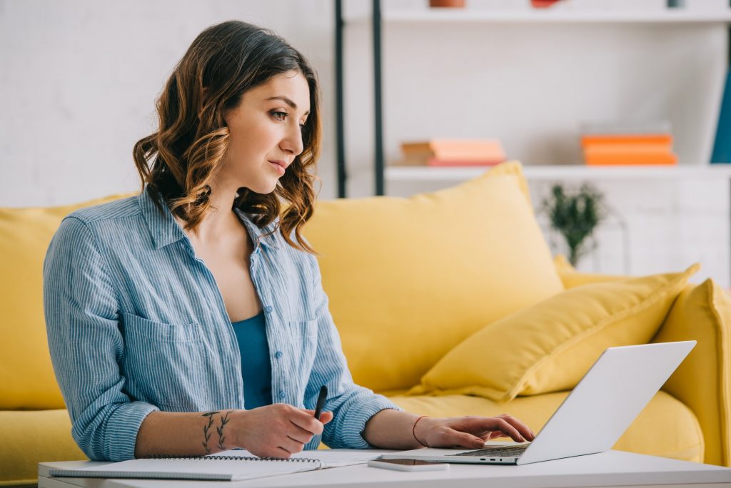 A woman preparing her resume on her laptop before uploading it to online job search sites