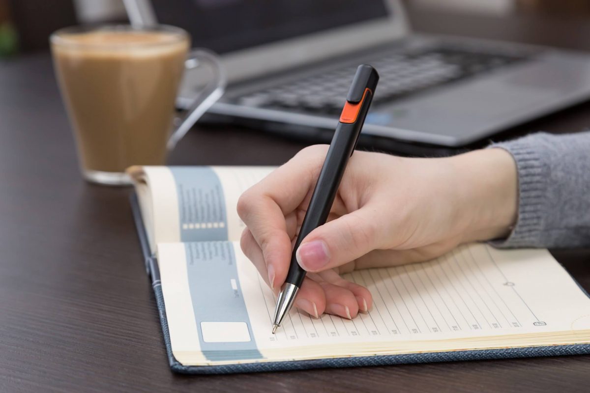 the girl plans her daily schedule on her journal