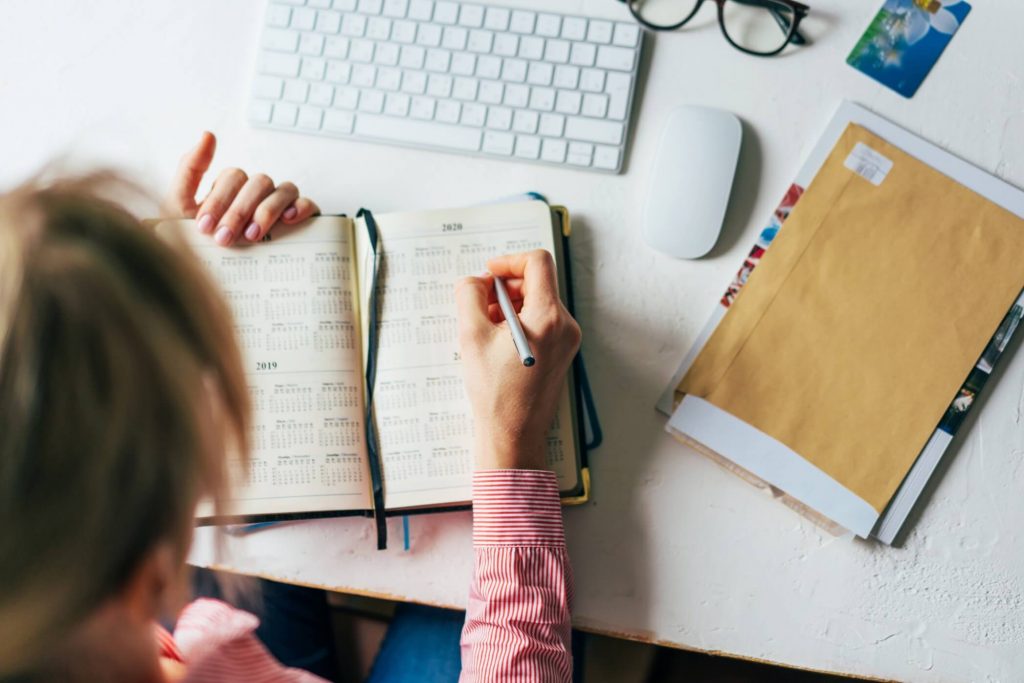 woman organizing her plans on her calendar